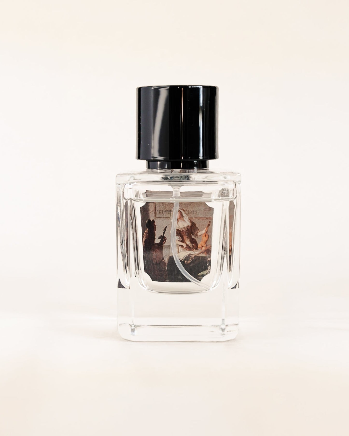 Perfume bottle with black cap on a light beige background
