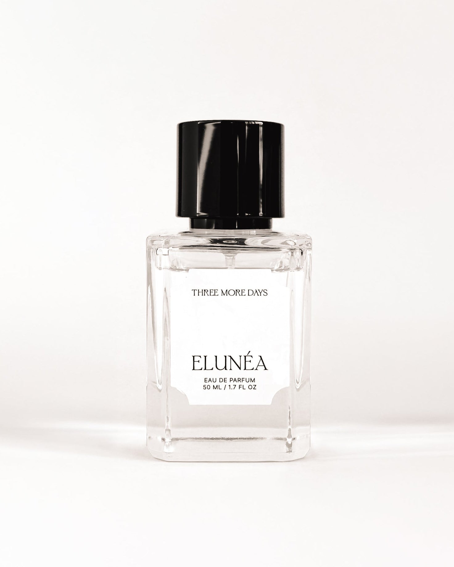 Perfume bottle with black cap on a white background
