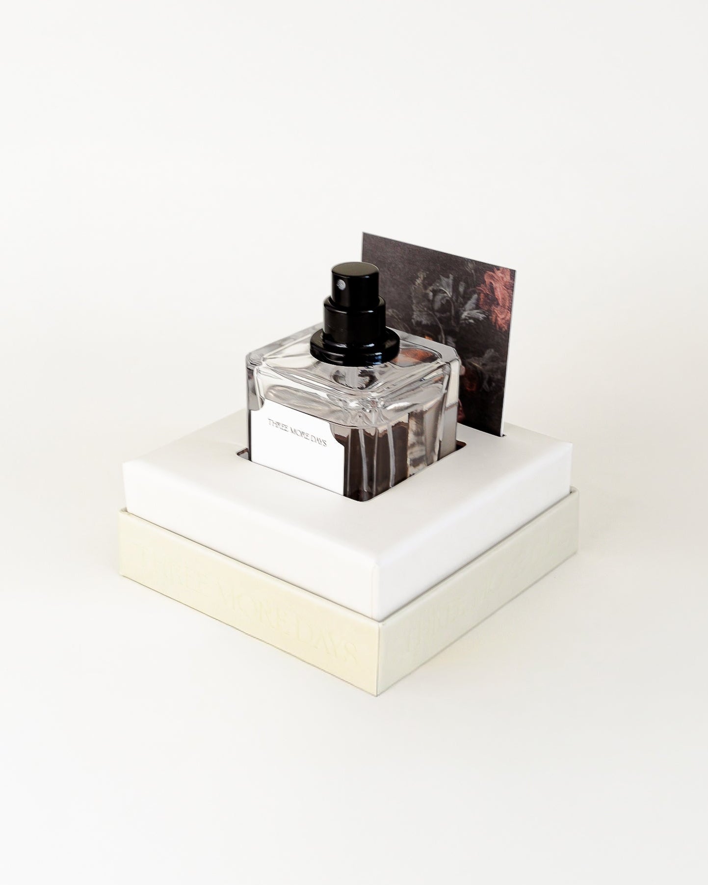 Small bottle of perfume on a white platform with a white background