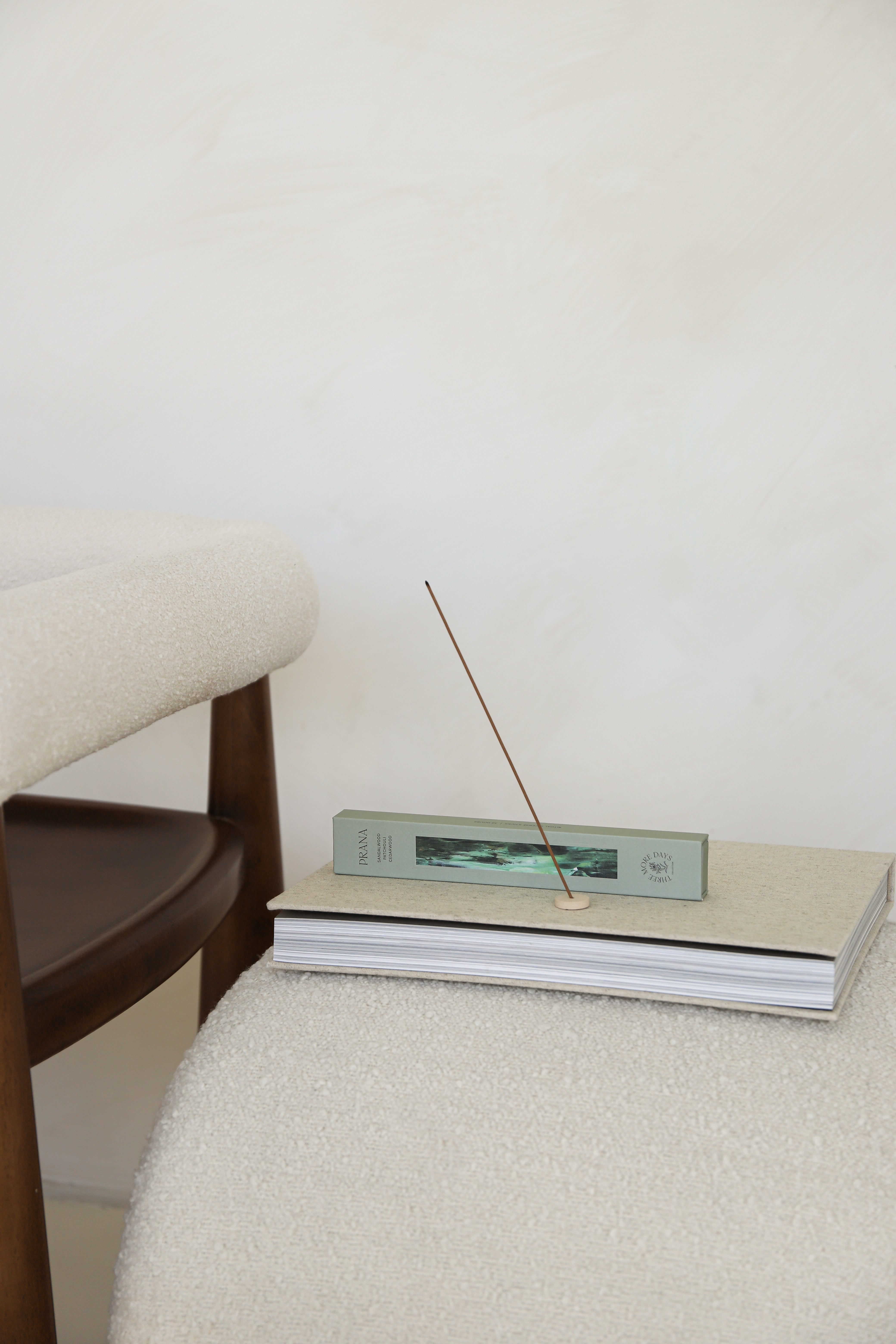 A collection of incense boxes from the Three More Days Collection, featuring Elixir, Aura, Chakra, and Prana. Elegantly designed with natural colors and artistic imagery, displayed under sunlight with stylish shadows.