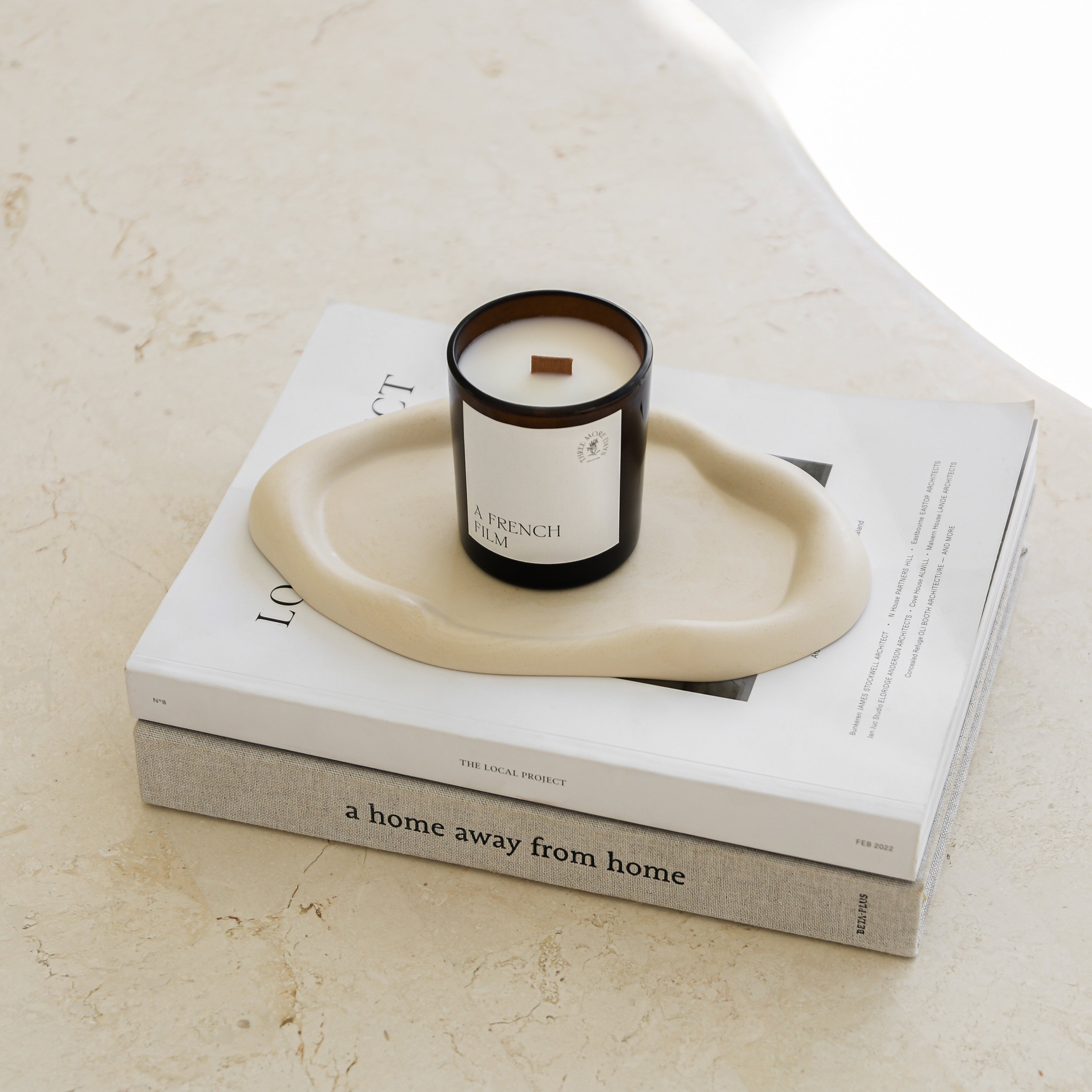 amber jar candle on books and places on a table