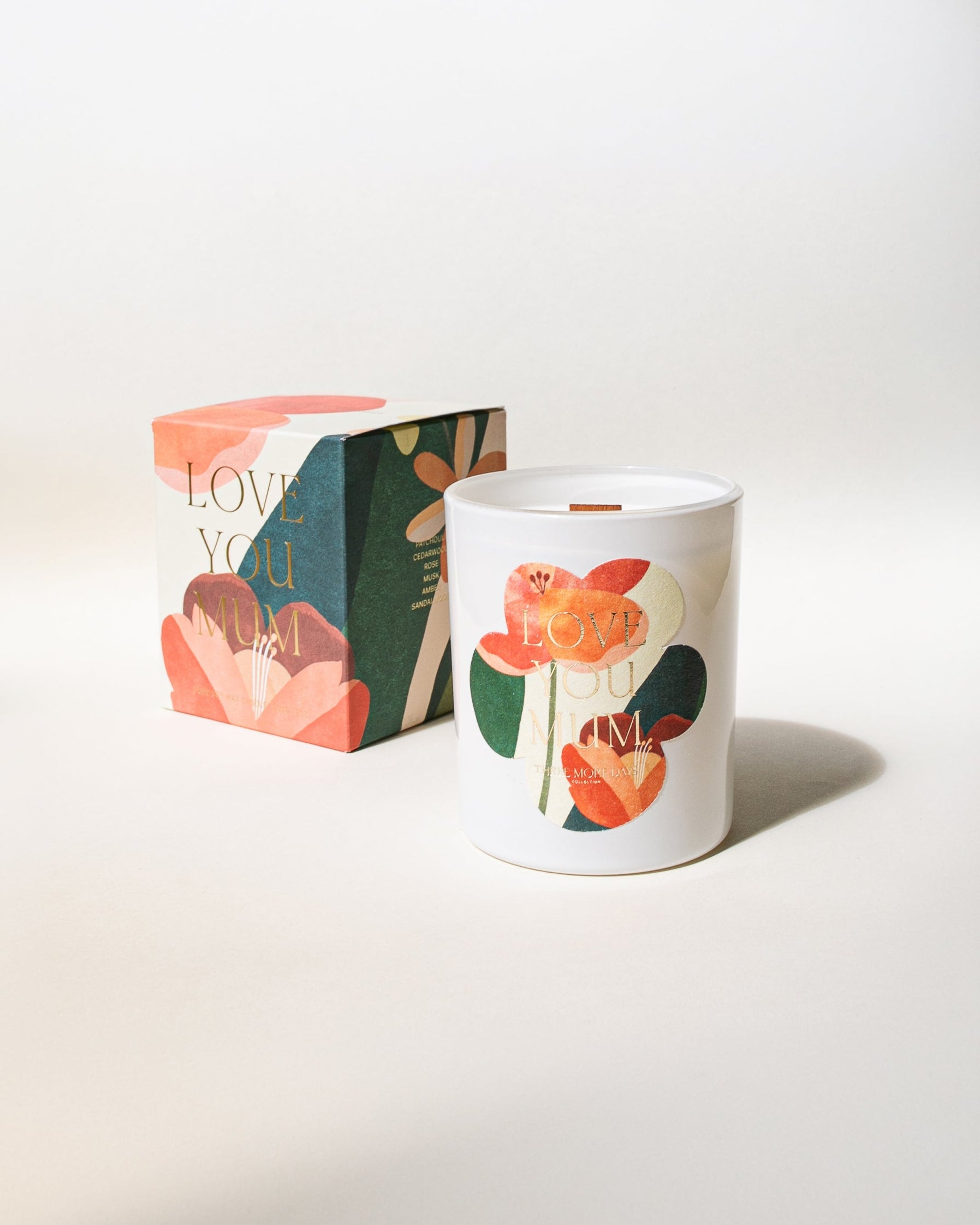 Floral-themed candle and packaging on a light background