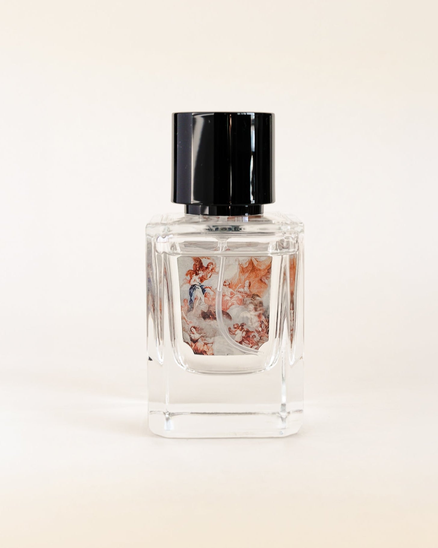 Perfume bottle with floral design on a light beige background