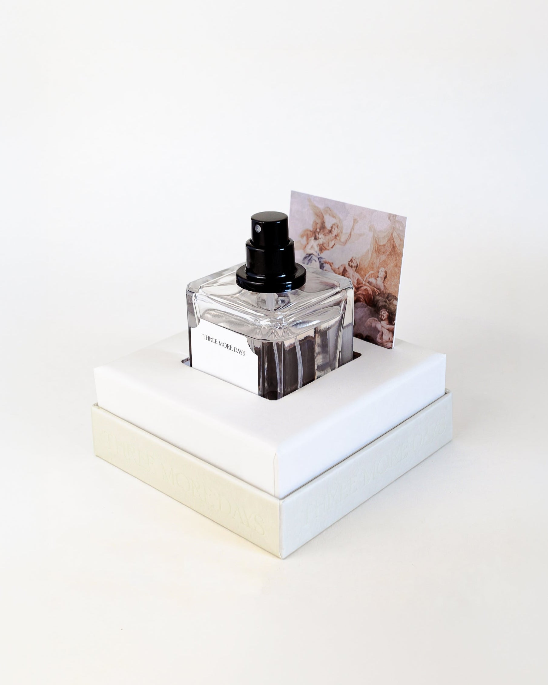 Perfume bottle on a white platform with a white background