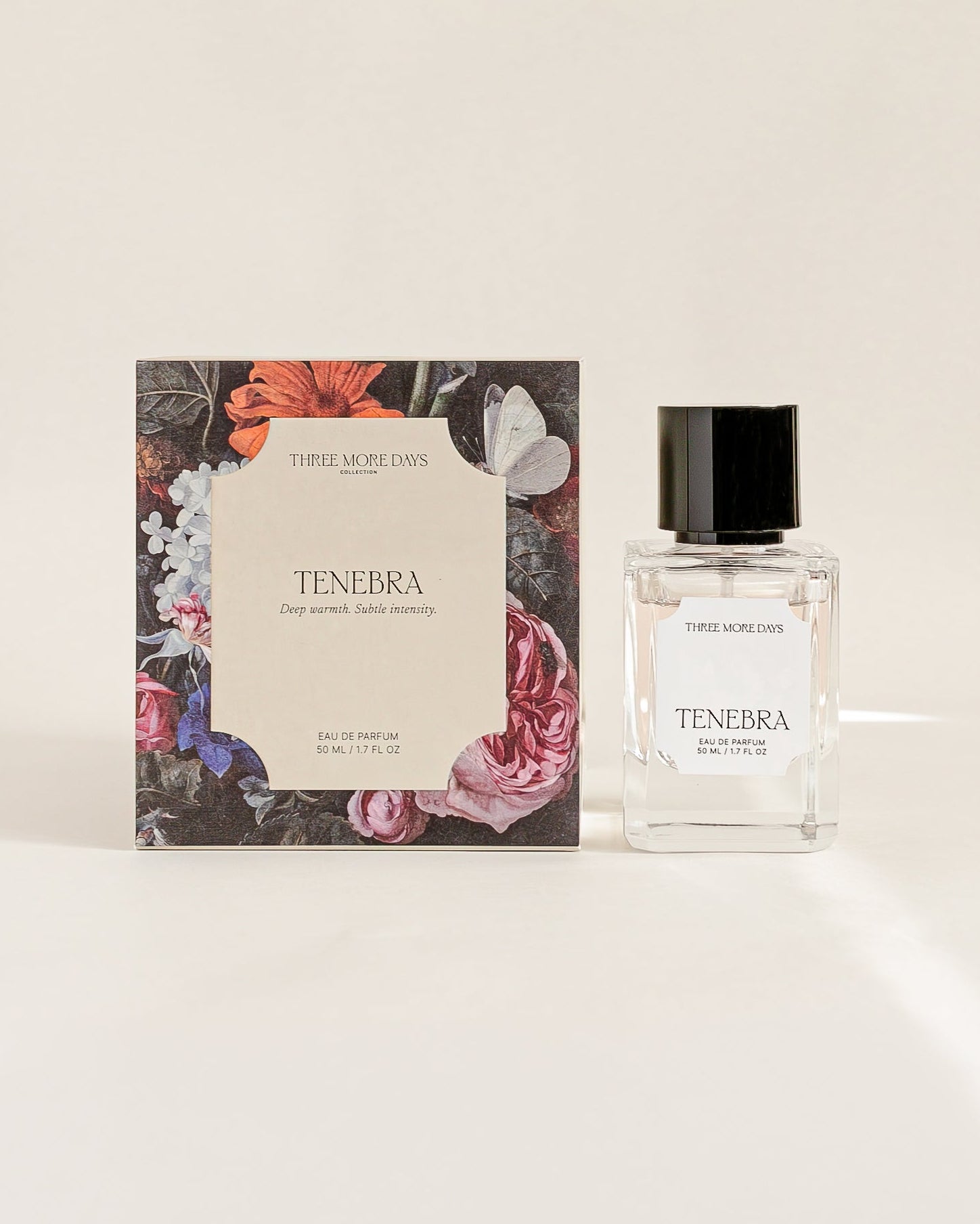 Perfume bottle and packaging with floral design on a white background