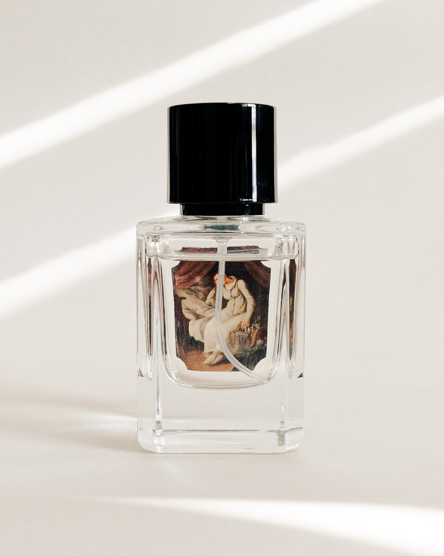 Perfume bottle with decorative label on a white surface
