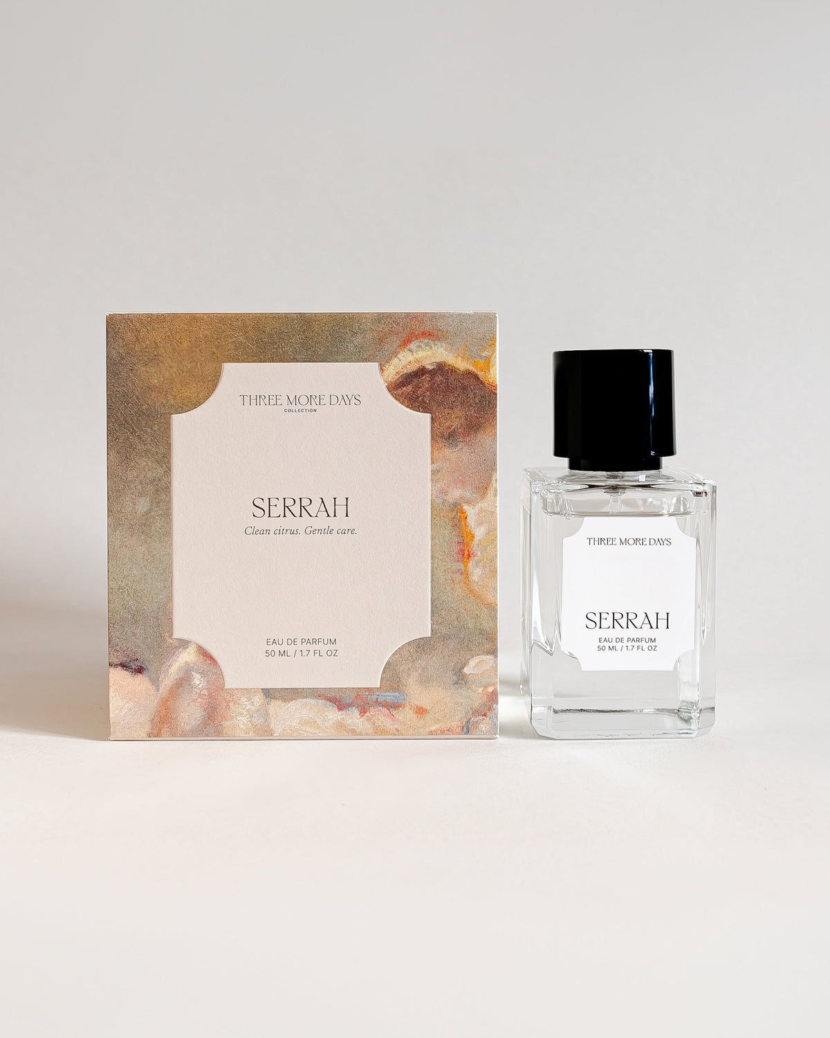 A small clear glass perfume bottle with a black cap stands next to its illustrated box on a clean white background. The box and bottle label both show the brand name 'SERRAH' and the scent name 'SOLIS'.