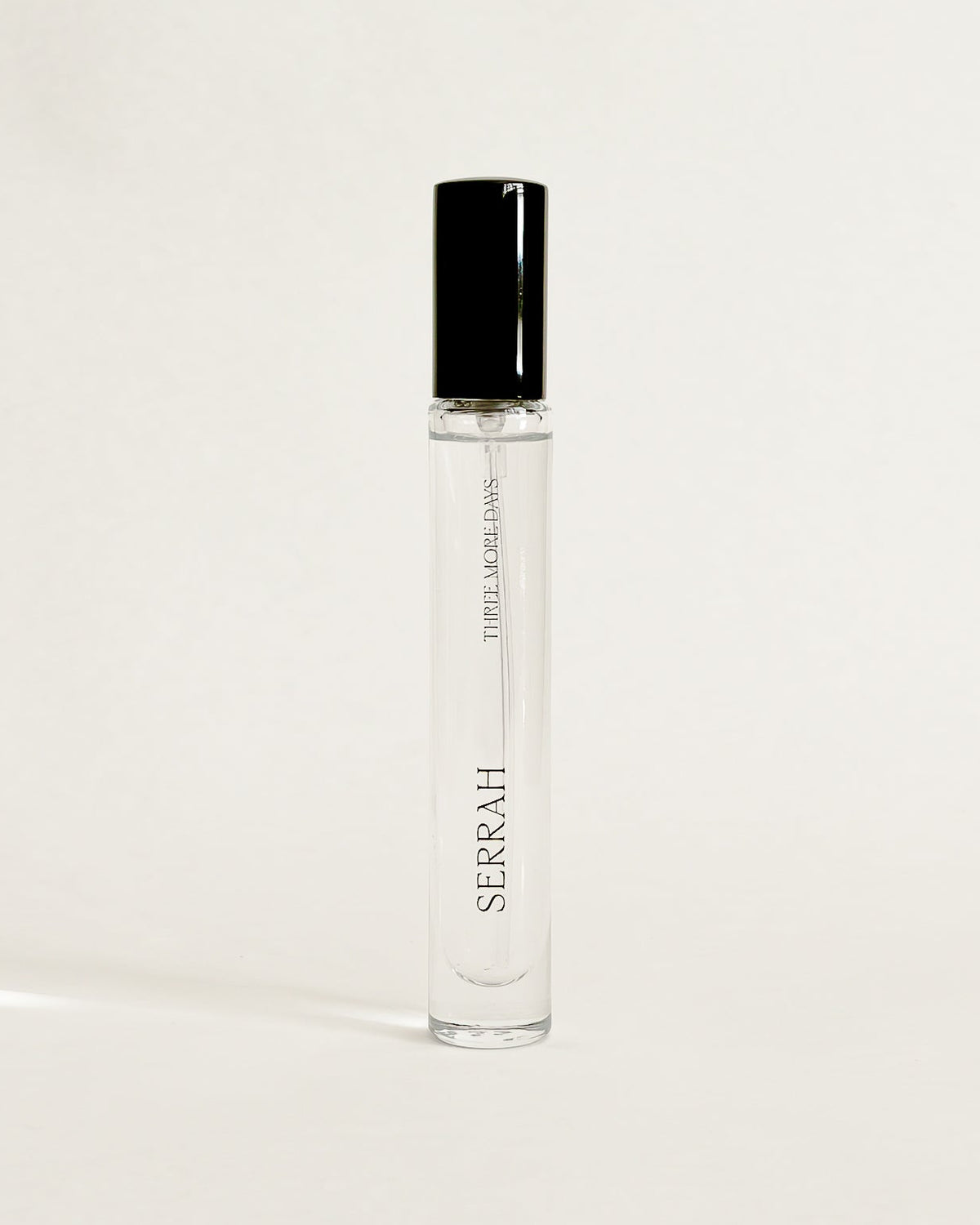 A clear glass perfume roller bottle with a black cap, standing upright on a white surface against a white backdrop. The brand name 'SORAH' is printed vertically on the bottle.